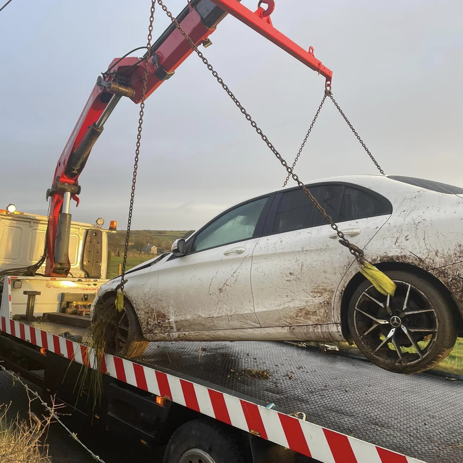 Crashed Merc getting lifted from field